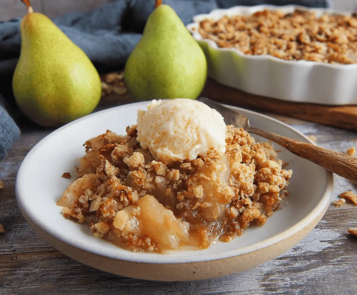 Delicious homemade pear crumble topped with golden, buttery crumble crust and fresh pear slices, served in a rustic bowl for a comforting dessert.