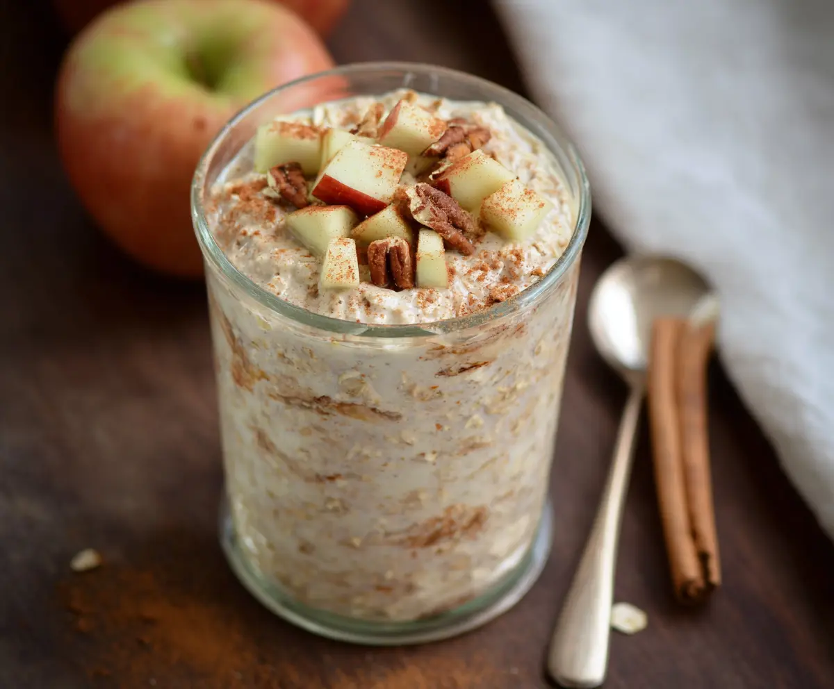 Healthy apple cinnamon protein overnight oats in a glass jar for breakfast