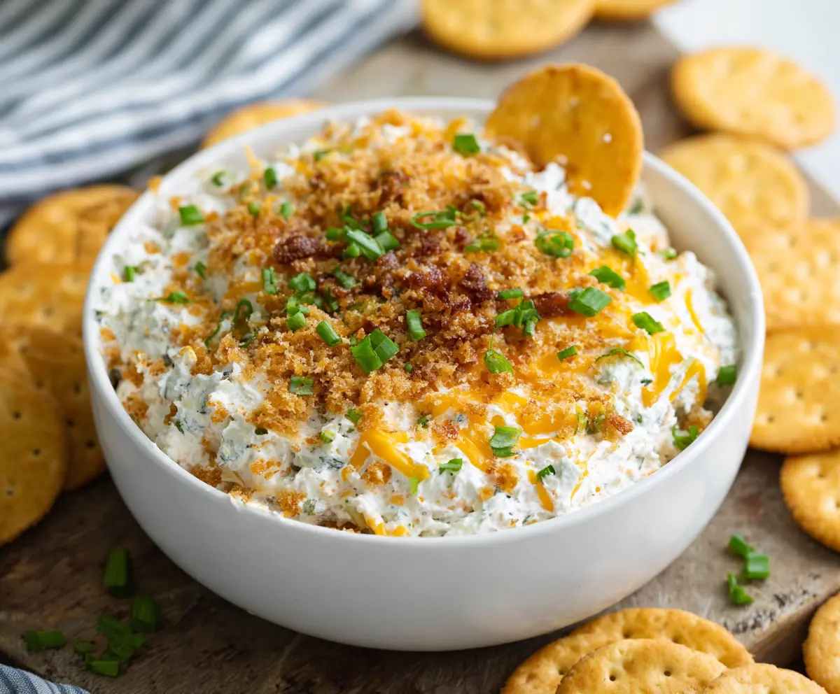 Creamy cheddar ranch crack dip served with crispy chips for a flavorful appetizer.