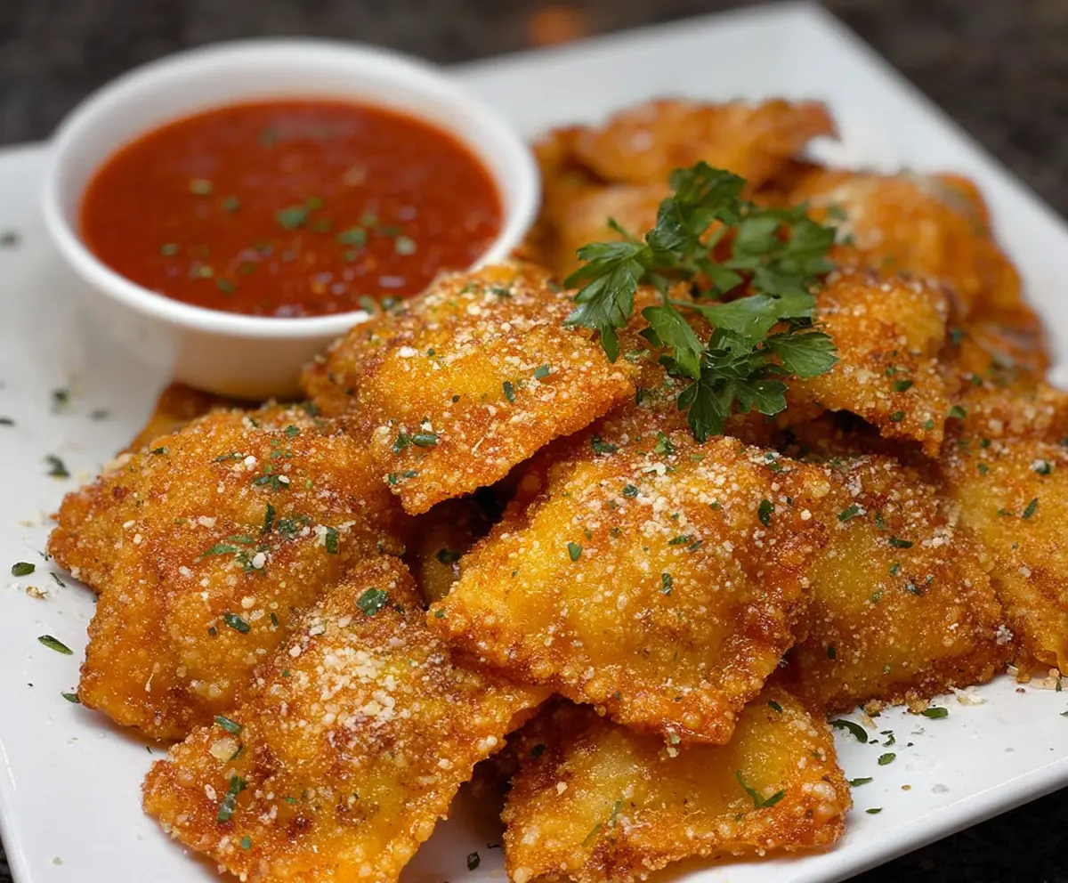 Crispy fried ravioli with melted cheese filling served with marinara sauce