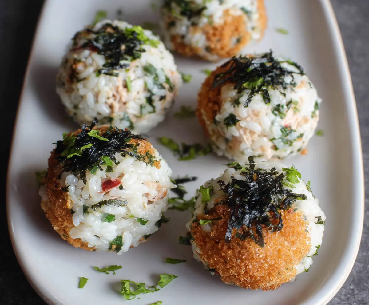 Delicious tuna rice balls on a plate, perfect for a quick Japanese snack.