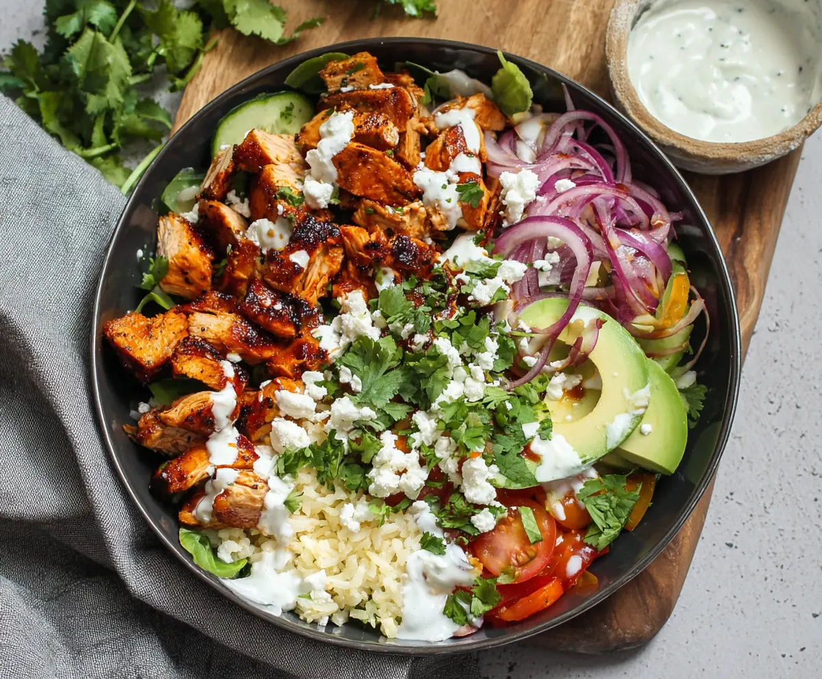 Delicious BBQ Chicken Cottage Cheese Bowl served in a bowl, garnished with fresh herbs.
