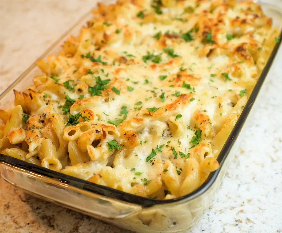 Creamy Cottage Cheese Alfredo Pasta Bake with golden cheese topping, perfect for a comforting dinner.