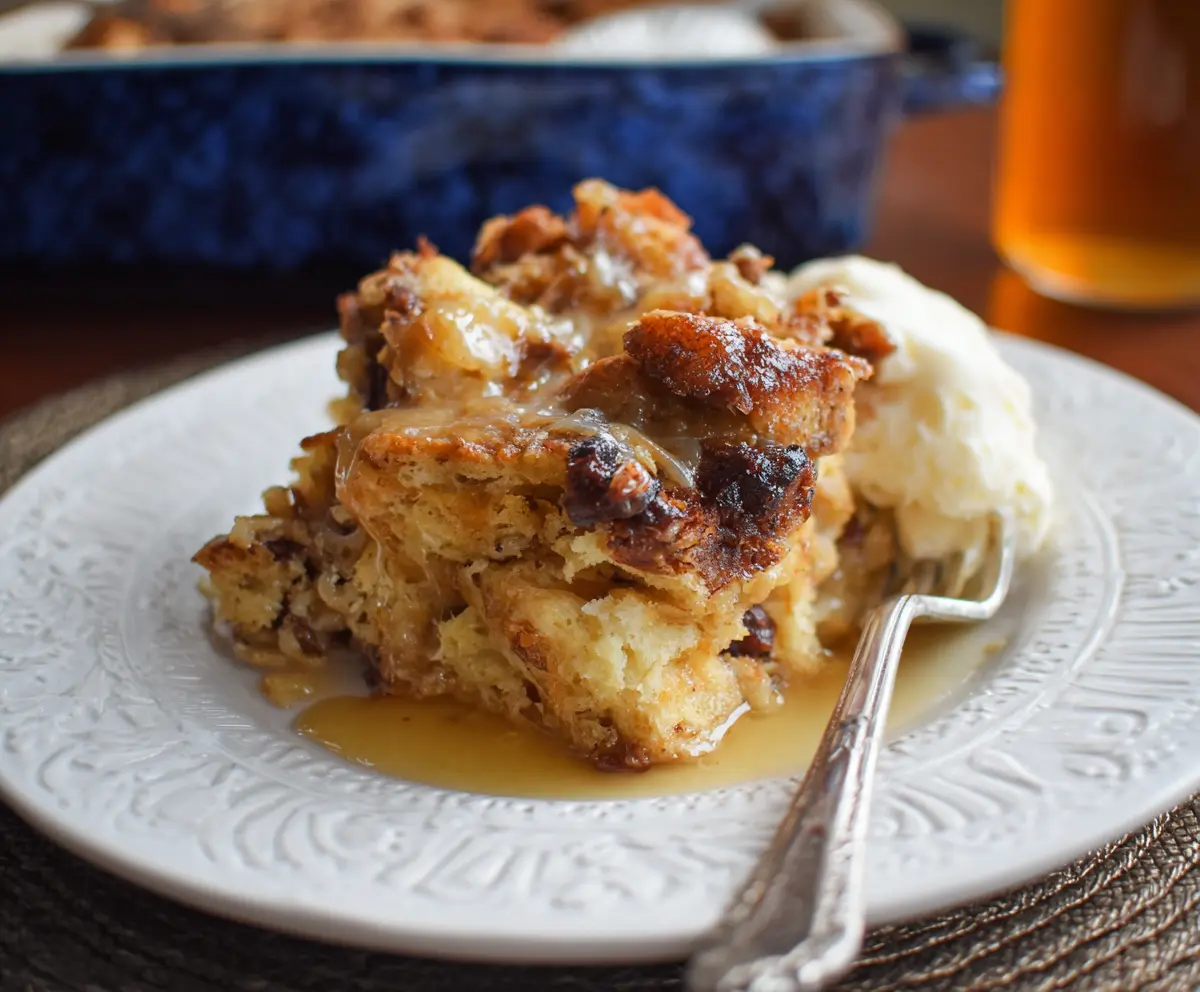 Delicious Sourdough Bread Pudding topped with cinnamon and powdered sugar, served warm in a rustic bowl.