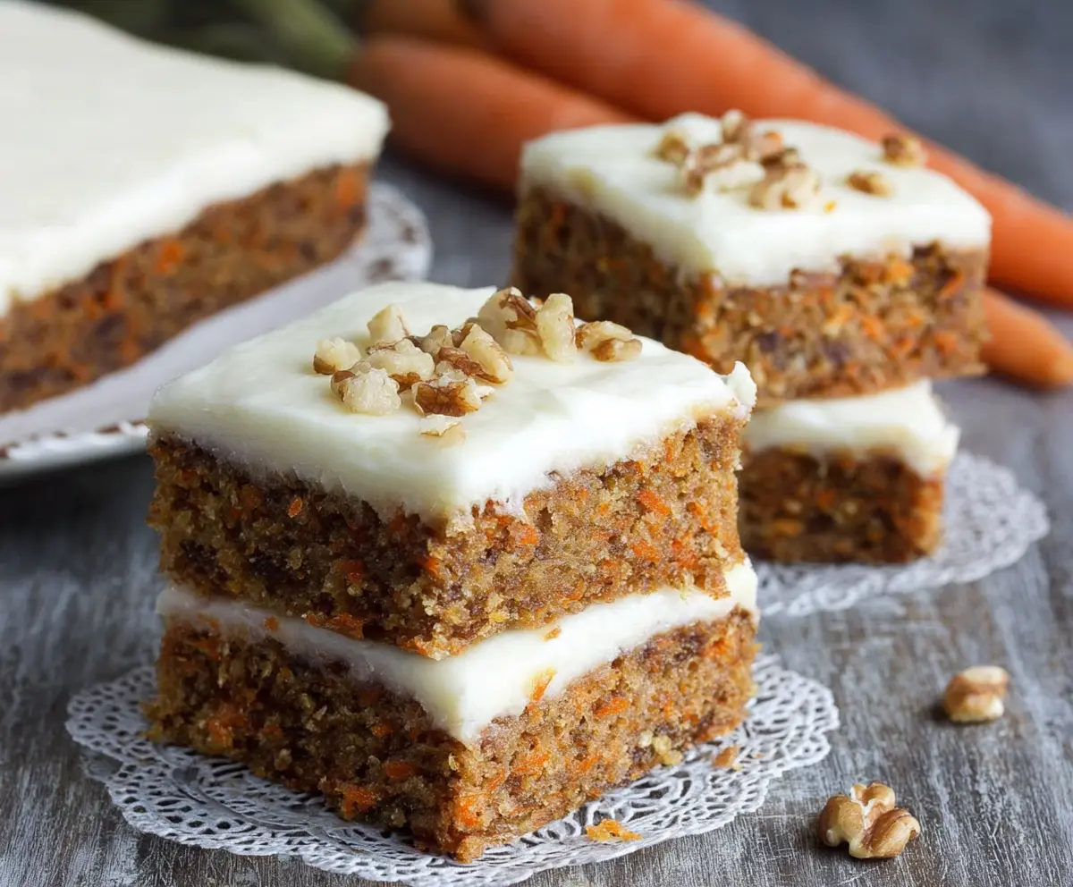 Delicious homemade carrot cake bars topped with creamy cream cheese frosting, perfect for dessert or snack.