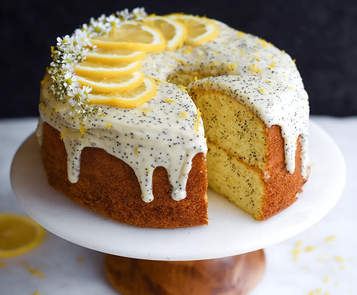 Delicious Lemon Poppy Seed Cake with a moist texture and a bright yellow color, garnished with lemon zest.